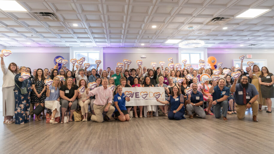 Nonprofit leaders with Give Day sign