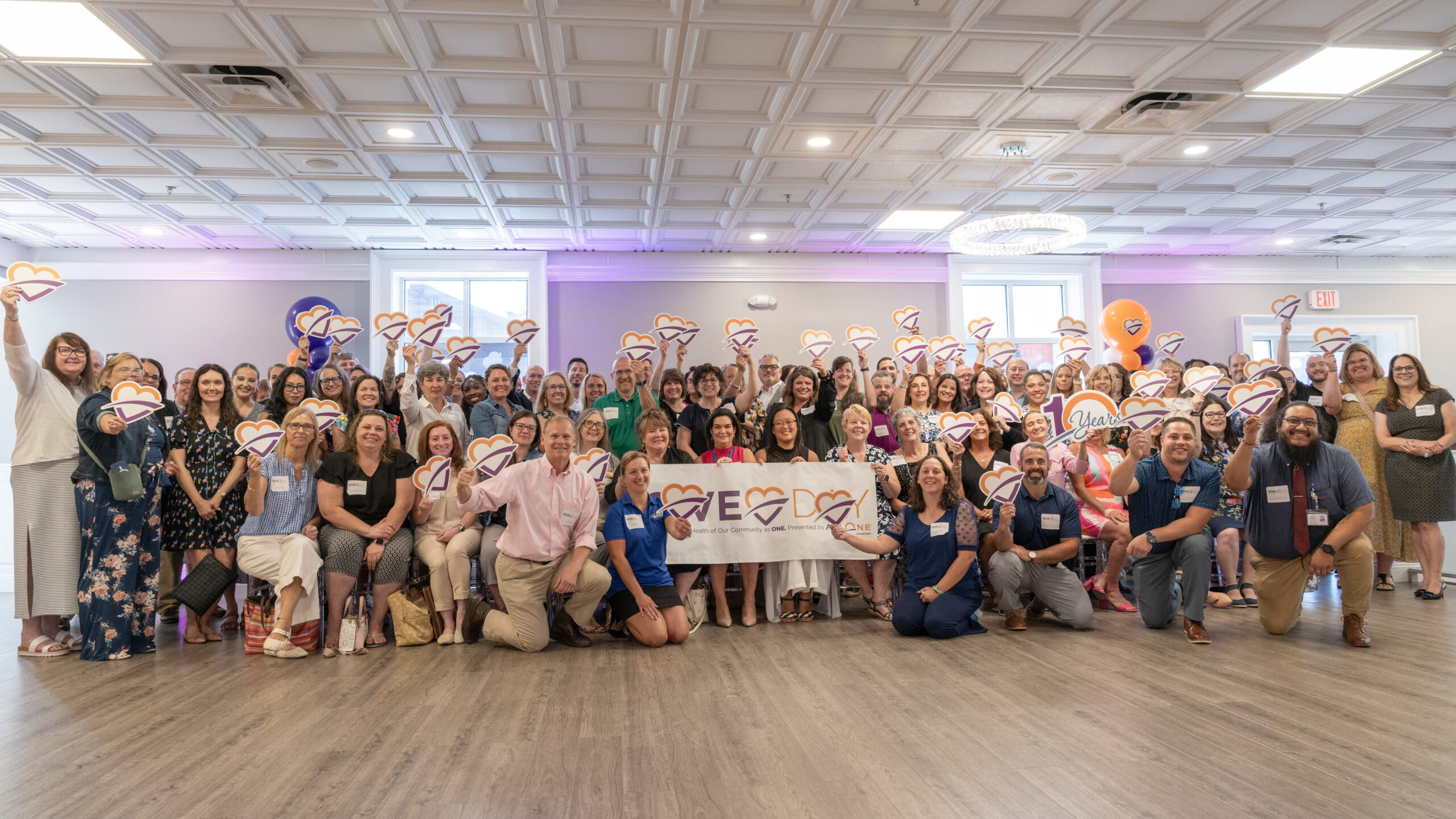 Nonprofit leaders with Give Day sign